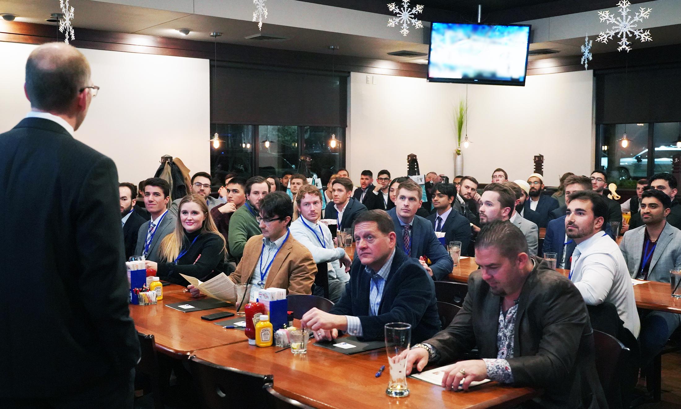 An image of attendees of the conference listening to Dr. 摩尔