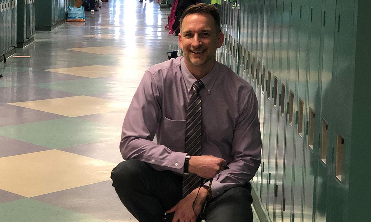 A man kneeling in a hallway