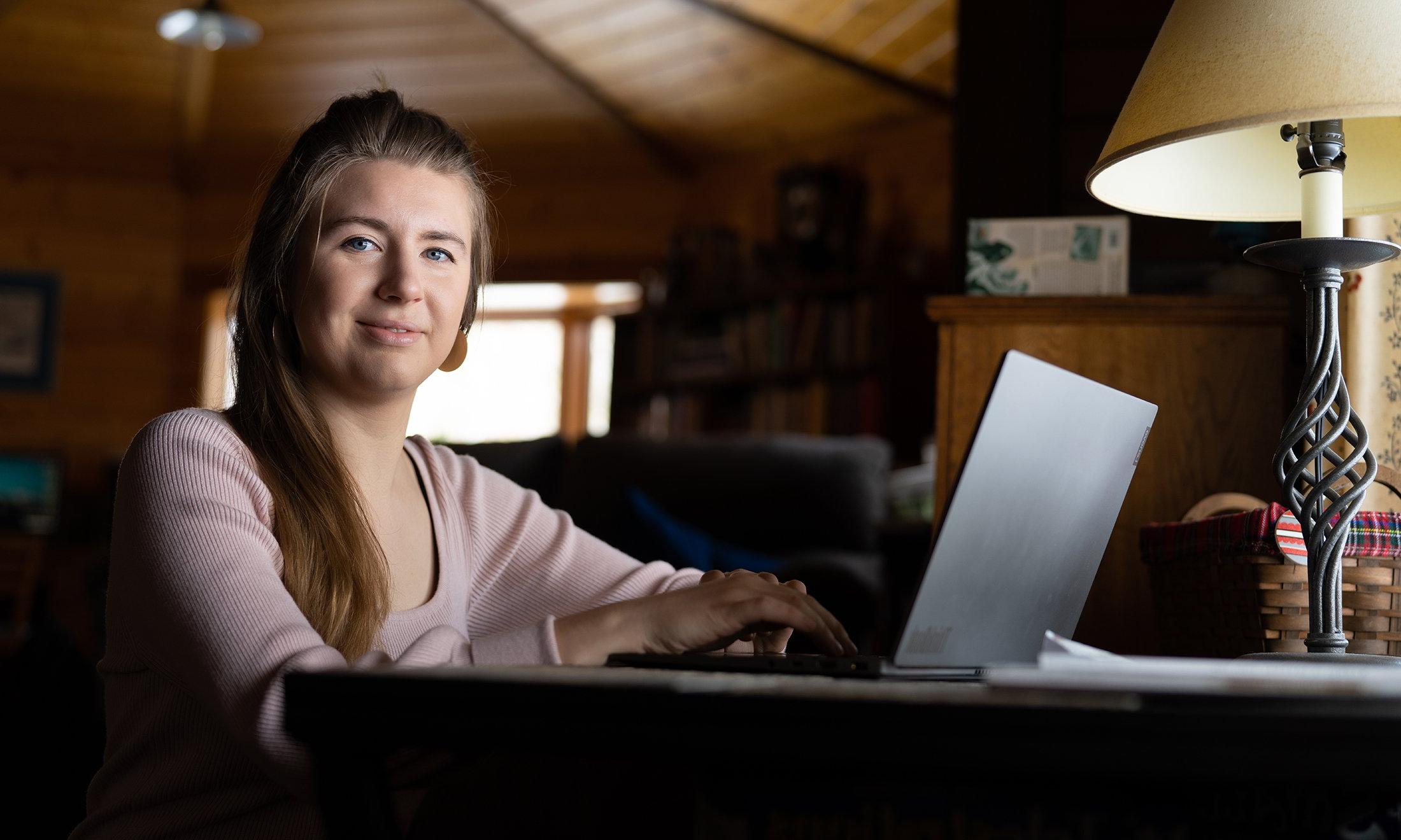 A woman sitting at a computer.